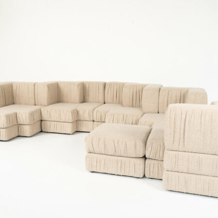 Contemporary Italian modular sofa in beige textured fabric with multiple sections, deep seats, and versatile modern design