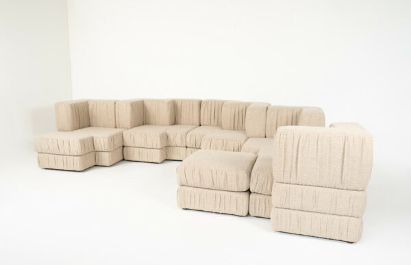 Contemporary Italian modular sofa in beige textured fabric with multiple sections, deep seats, and versatile modern design