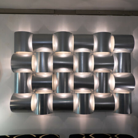 Contemporary Italian modular wall light in brushed aluminium with sculptural curved forms and ambient diffused glow