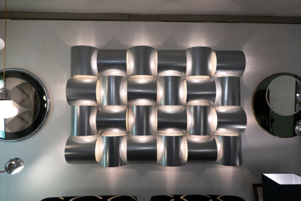 Contemporary Italian modular wall light in brushed aluminium with sculptural curved forms and ambient diffused glow