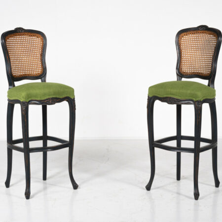 Pair of Louis XV style bar stools with cane backs, dark wood frames, and green upholstered seats on cabriole legs.