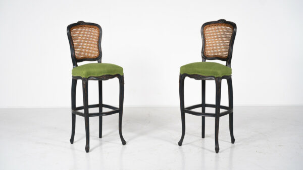 Pair of Louis XV style bar stools with cane backs, dark wood frames, and green upholstered seats on cabriole legs.